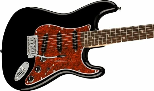 Black electric guitar with a brown pickguard and player's hands on the fretboard